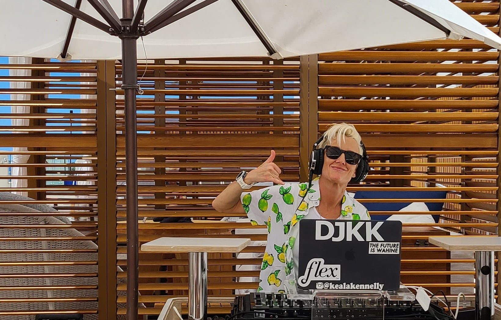 DJ KK with shaka sign in Longboard cabana