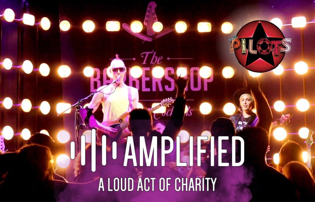 Pilots Band lead singer on stage with Amplified a loud act of charity text