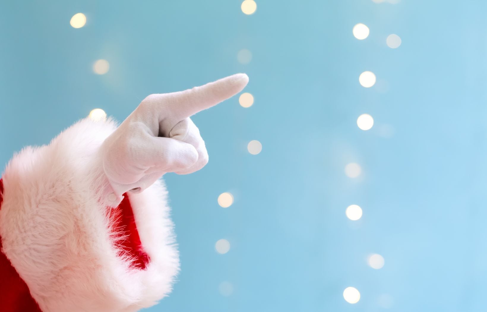 Close up of Santa's finger with blue background