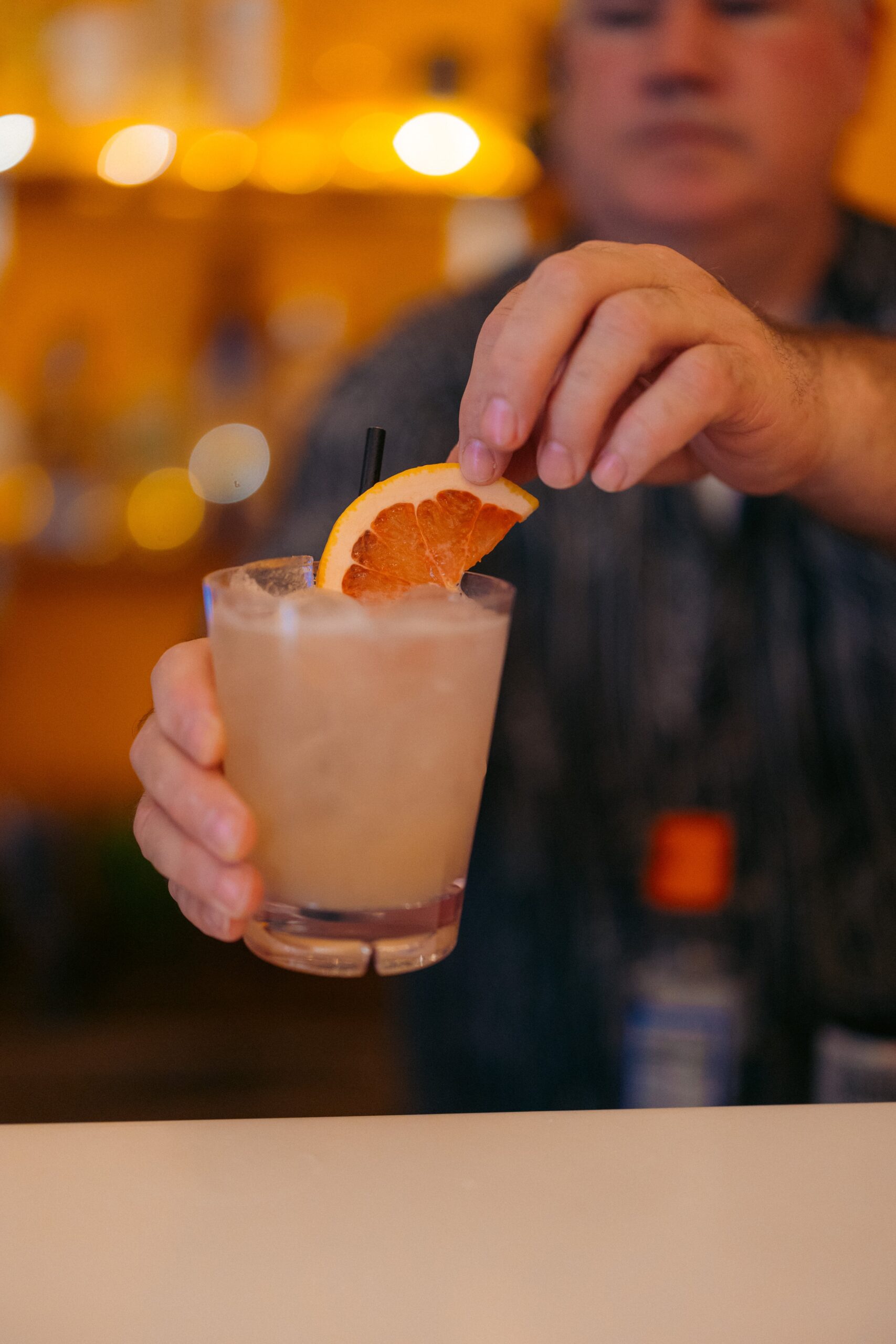 close up of tequila with orange wedge